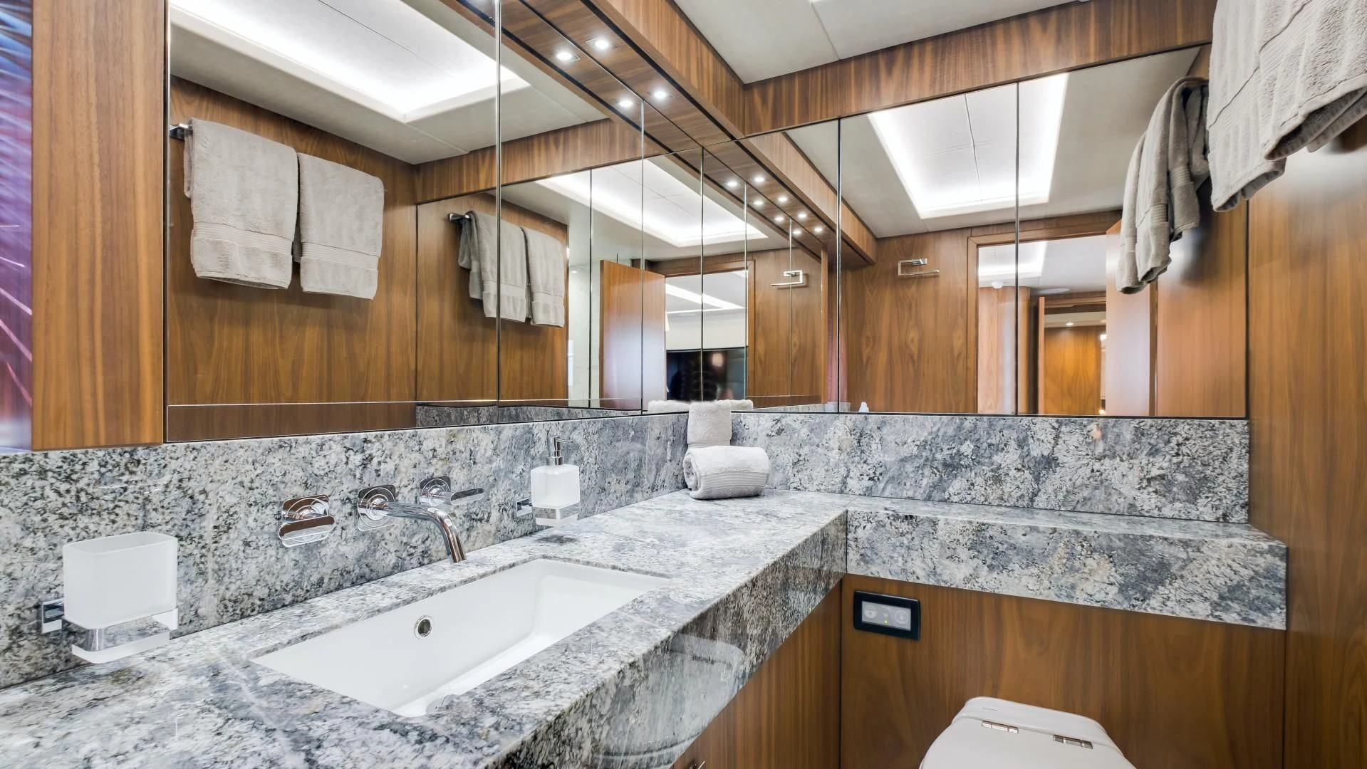 a bathroom with a countertop sink and a large mirror aboard SKYCHASER Yacht for Sale