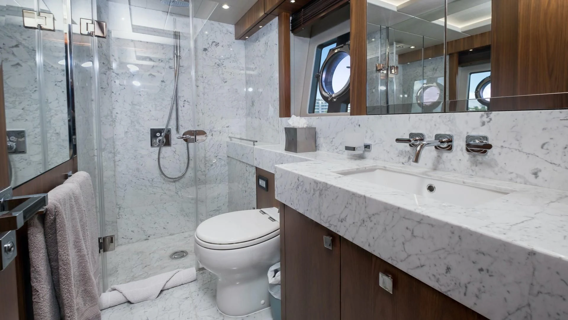 a bathroom with a sink toilet and a mirror aboard SKYCHASER Yacht for Sale