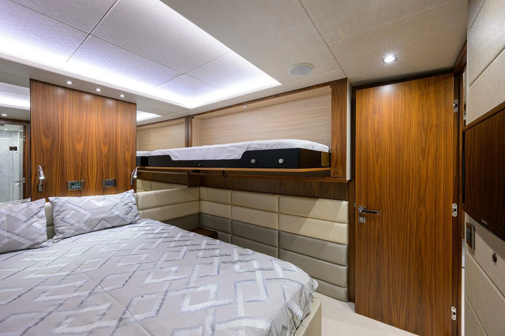a bedroom with a bed and a closet aboard SKYCHASER Yacht for Sale