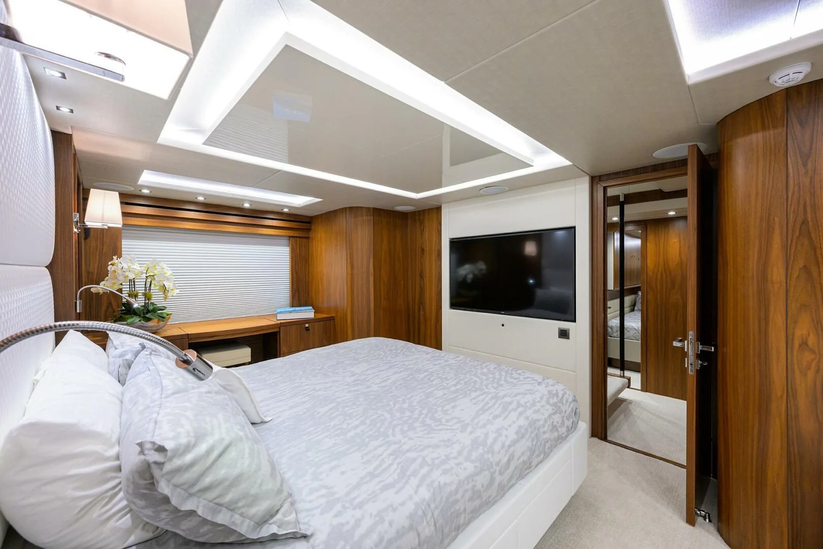 a room with a bed and a television aboard SKYCHASER Yacht for Sale