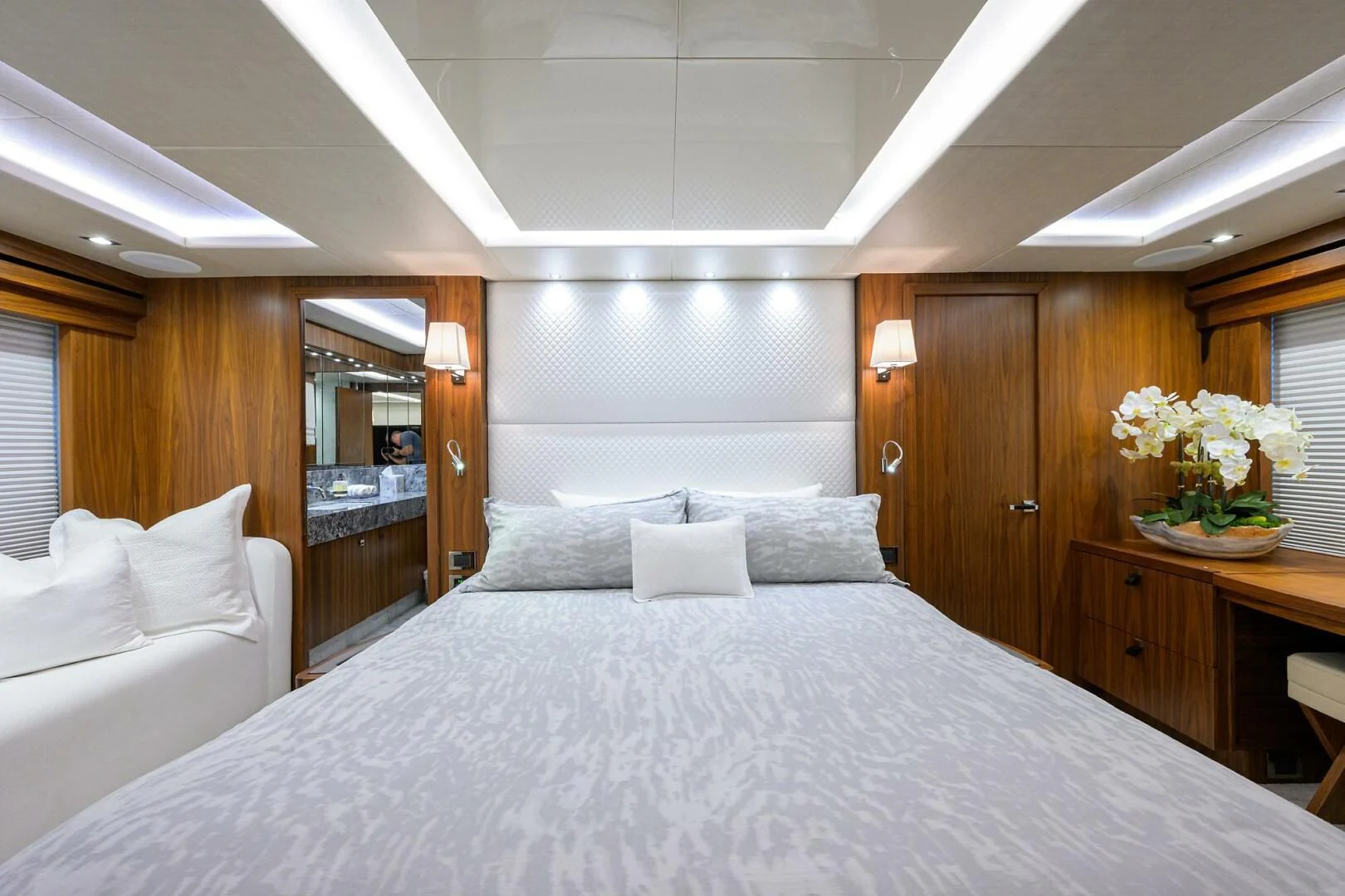 a bed with white sheets and pillows aboard SKYCHASER Yacht for Sale