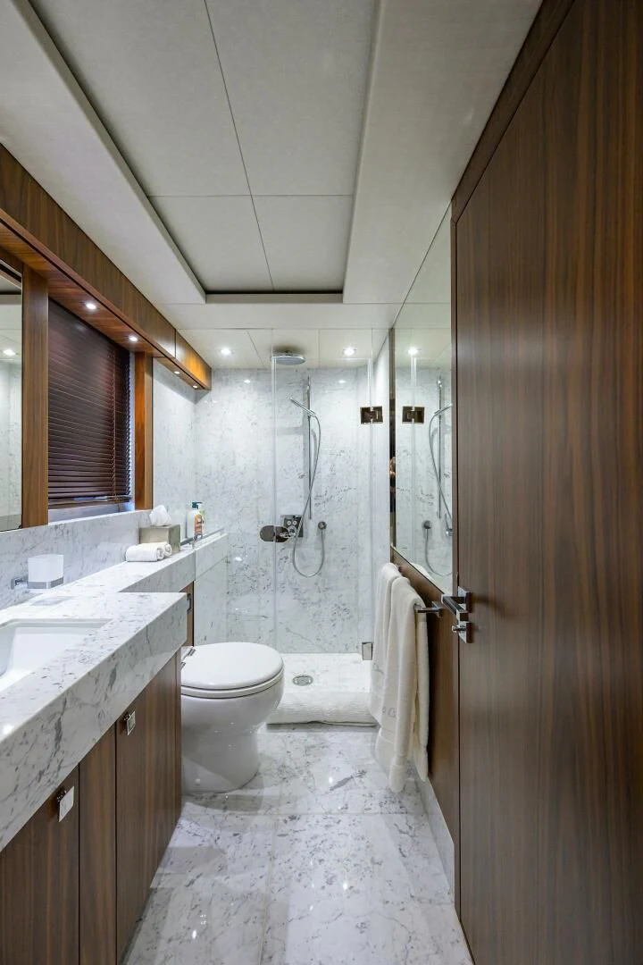 a bathroom with a toilet sink and a shower unit aboard SKYCHASER Yacht for Sale