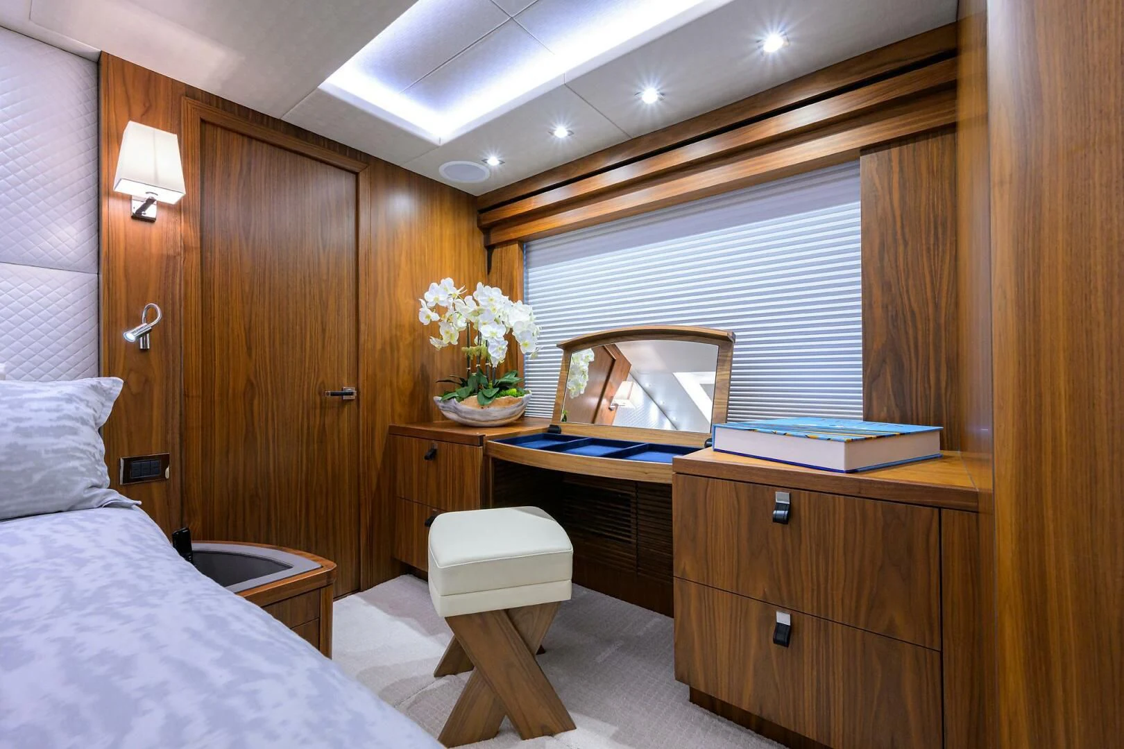 a room with a bed and a desk aboard SKYCHASER Yacht for Sale