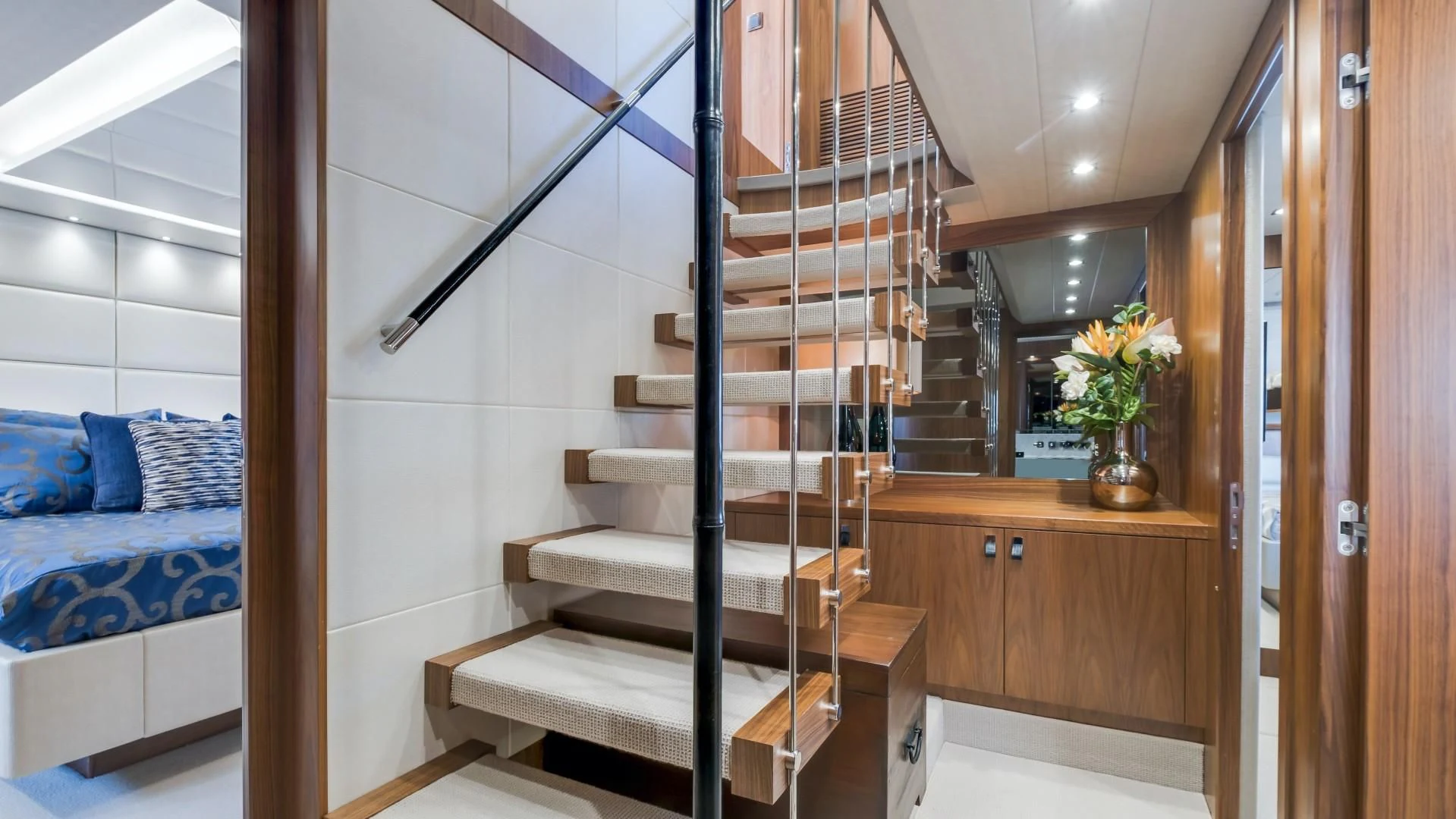 a room with a bed and a staircase aboard SKYCHASER Yacht for Sale