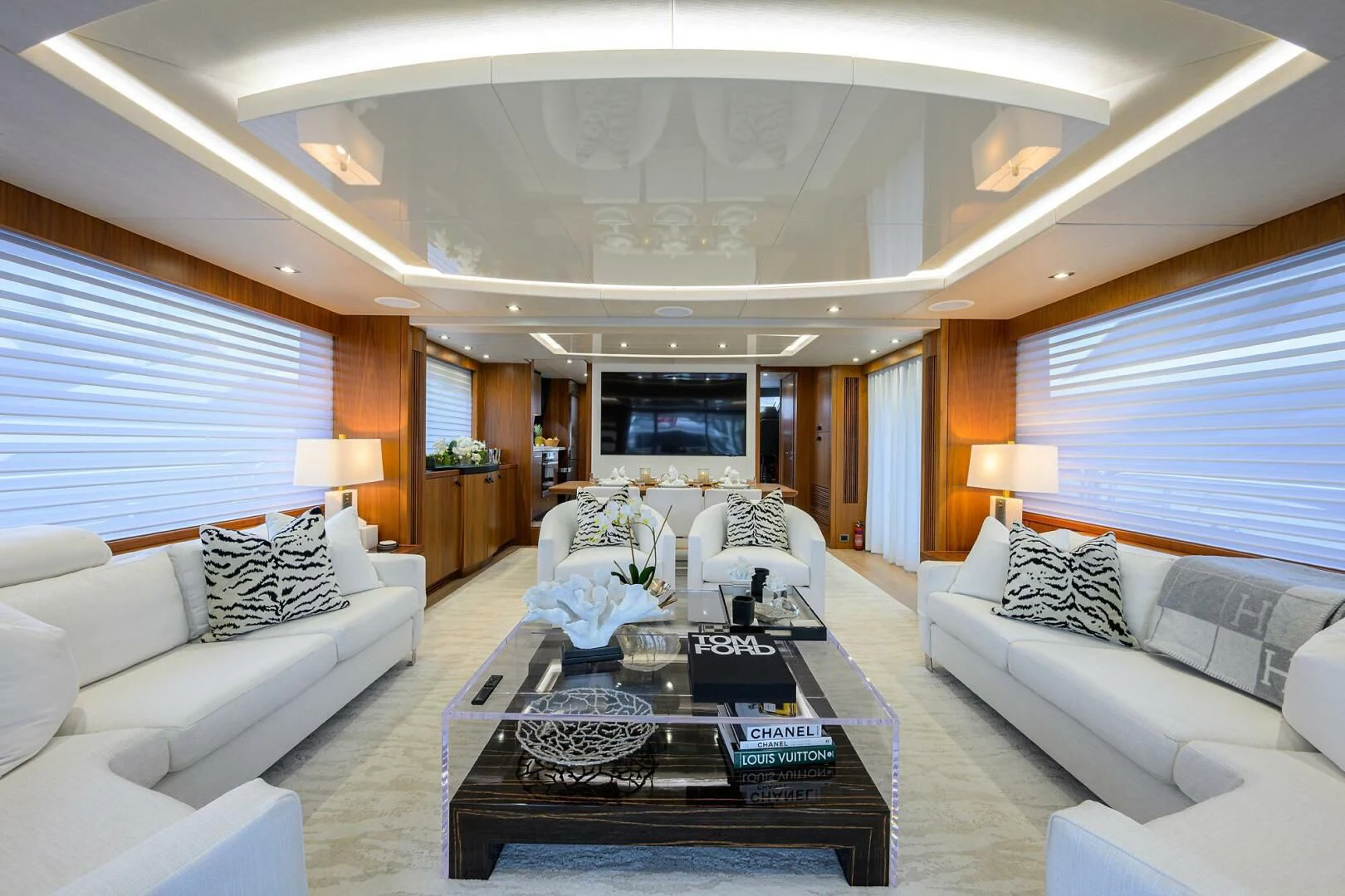 a living room with white couches and a coffee table aboard SKYCHASER Yacht for Sale