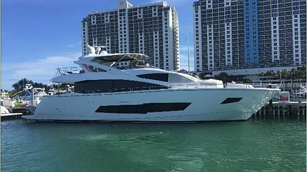 a white yacht in a harbor aboard SKYCHASER Yacht for Sale