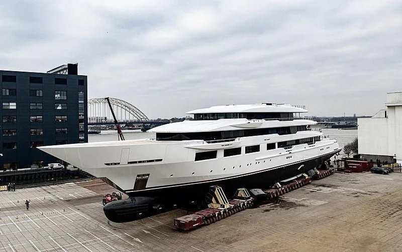 a large white boat sits on a dock aboard SHODAN Yacht for Sale