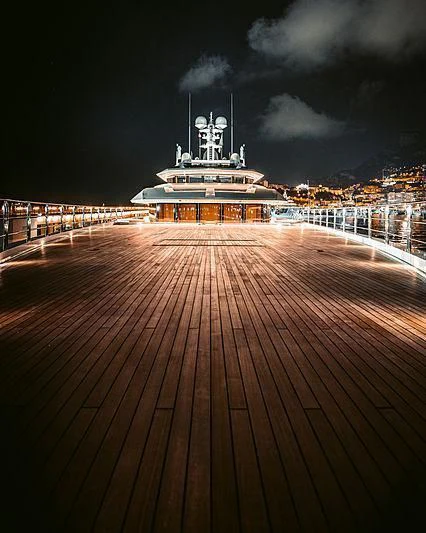 a large cruise ship at night aboard SHODAN Yacht for Sale