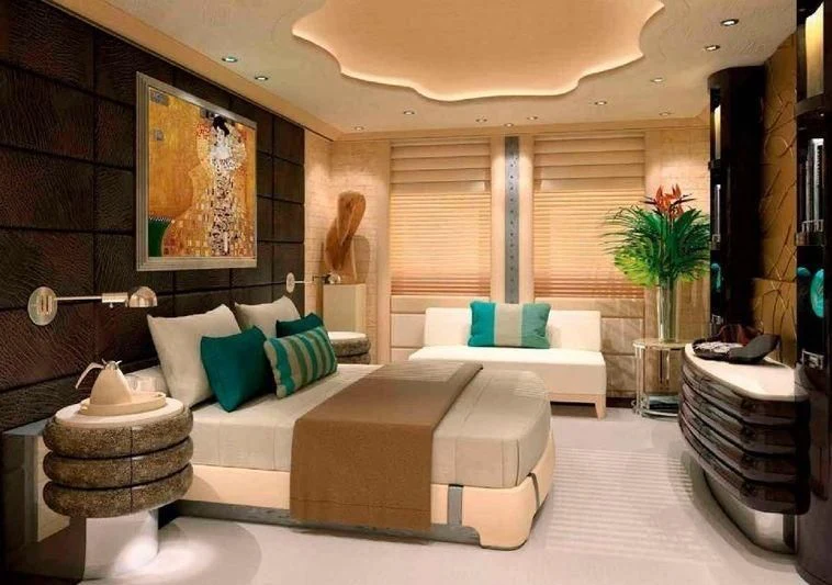 a modern looking room with a white couch and a plant aboard SHODAN Yacht for Sale