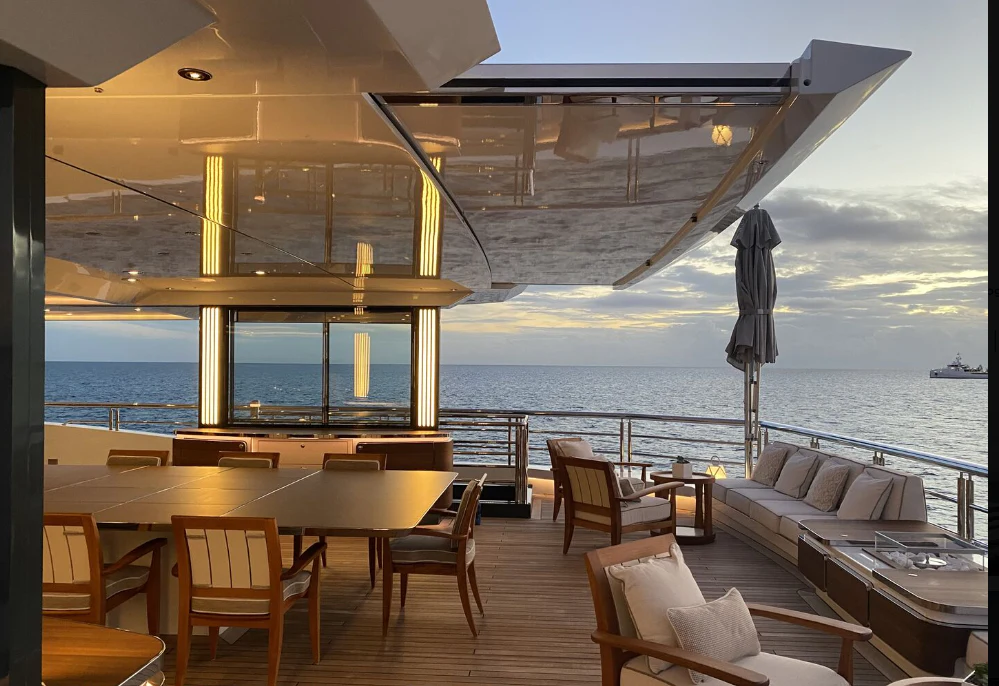 a room with a view of the ocean and a boat aboard SHODAN Yacht for Sale
