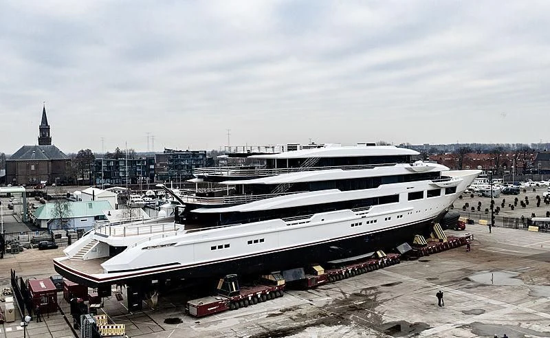 a large cruise ship docked aboard SHODAN Yacht for Sale
