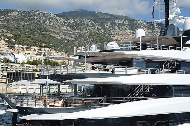 a building with a roof and a mountain in the background aboard SHODAN Yacht for Sale