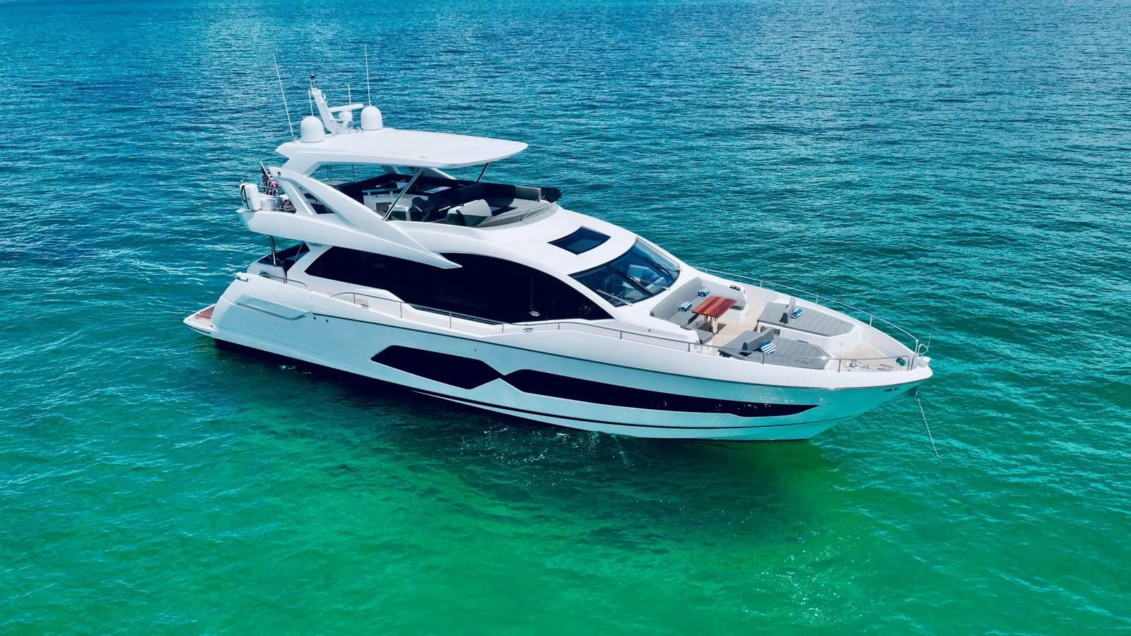a white yacht in the water aboard DO IT ANYWAY Yacht for Sale