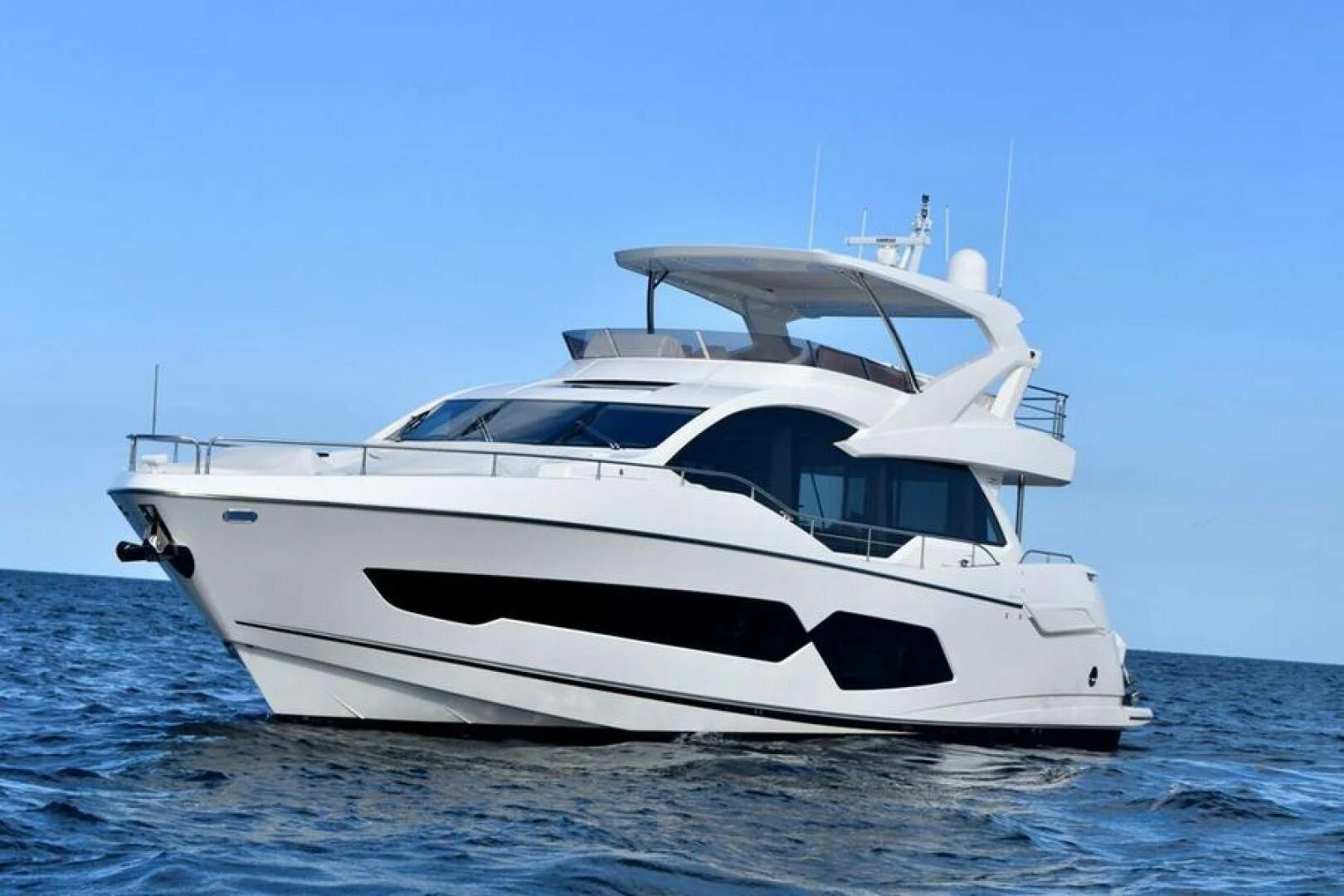 a white yacht in the water aboard DO IT ANYWAY Yacht for Sale