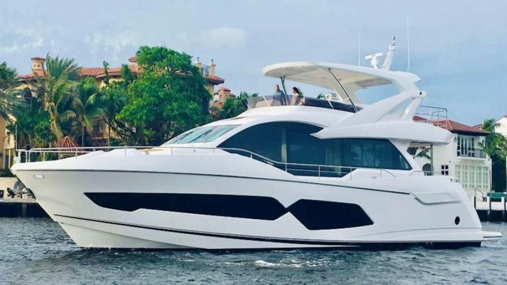 a white yacht on the water aboard DO IT ANYWAY Yacht for Sale