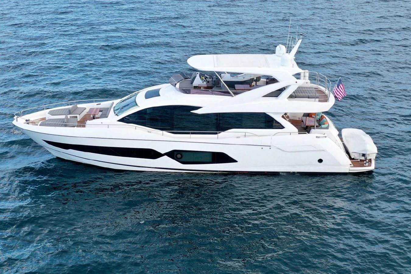 a white yacht on the water aboard DO IT ANYWAY Yacht for Sale