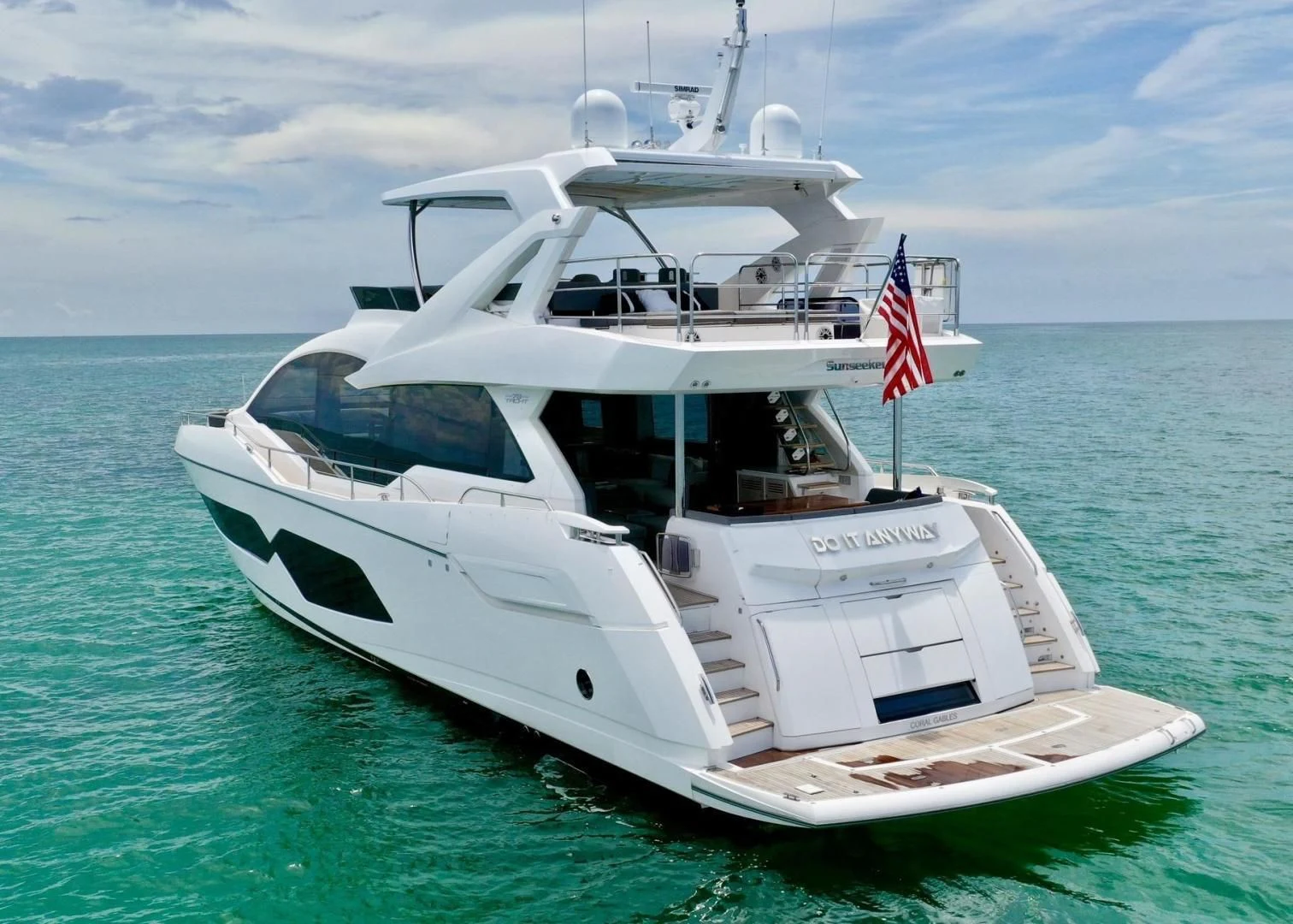 a white yacht in the water aboard DO IT ANYWAY Yacht for Sale