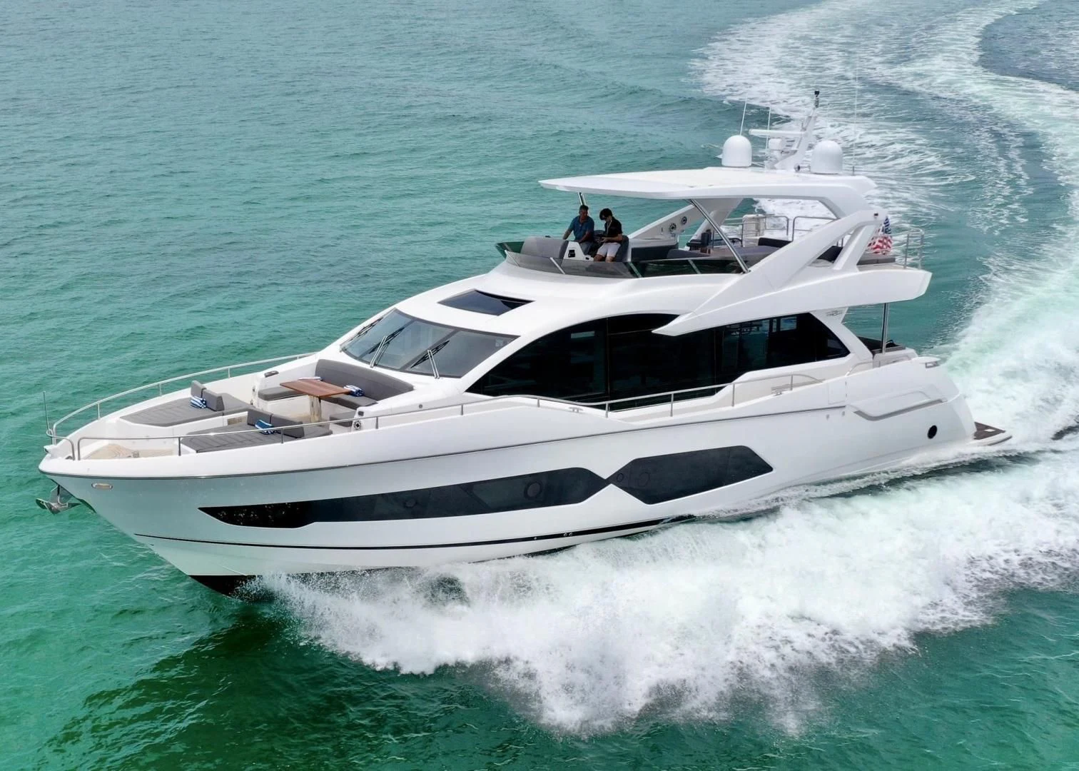 a white yacht on the water aboard DO IT ANYWAY Yacht for Sale