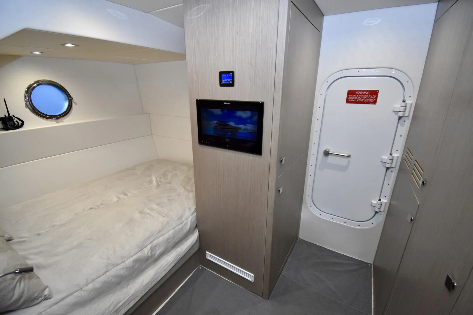 a room with a bed and a television aboard DO IT ANYWAY Yacht for Sale
