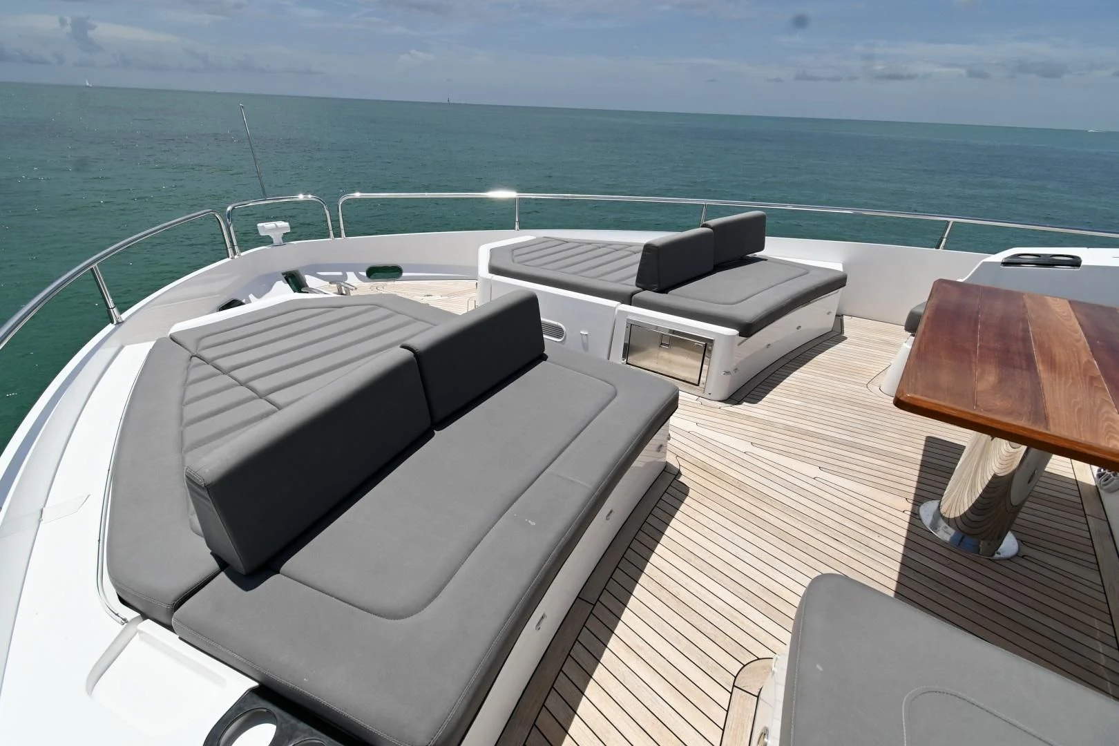 a room with a bed and a table and chairs on it aboard DO IT ANYWAY Yacht for Sale