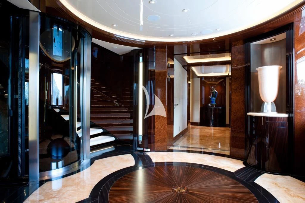 a hallway with a staircase and a glass door aboard ARIENCE Yacht for Sale