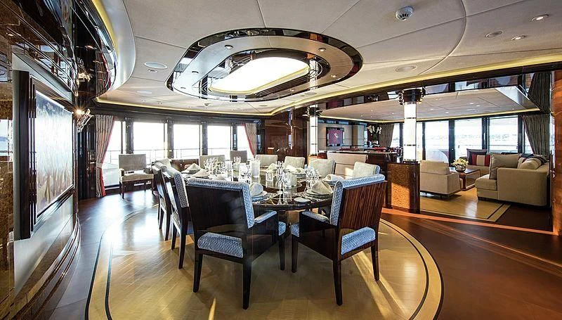 a large room with tables and chairs aboard ARIENCE Yacht for Sale