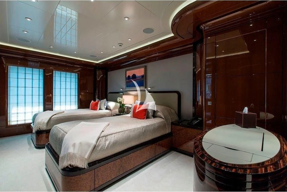 a room with a bed and a table aboard ARIENCE Yacht for Sale