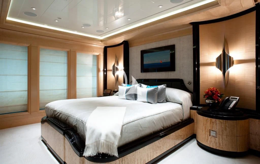 a bedroom with a bed and a desk aboard ARIENCE Yacht for Sale