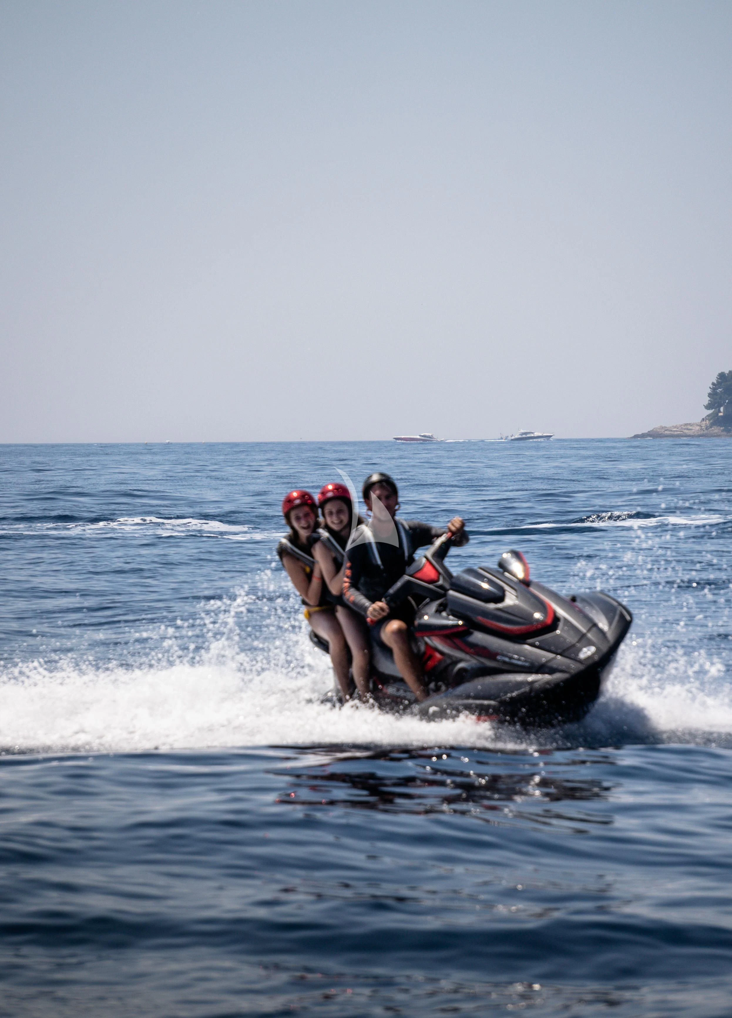 a group of people riding a jet ski in the water aboard ARIENCE Yacht for Sale