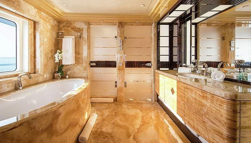 a bathroom with a tub and sinks aboard ARIENCE Yacht for Sale