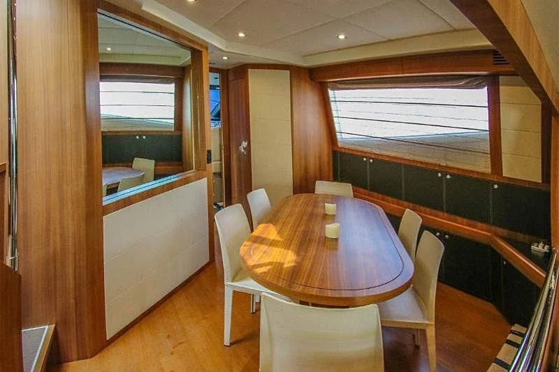 a table and chairs in a room aboard SPYRO Yacht for Sale
