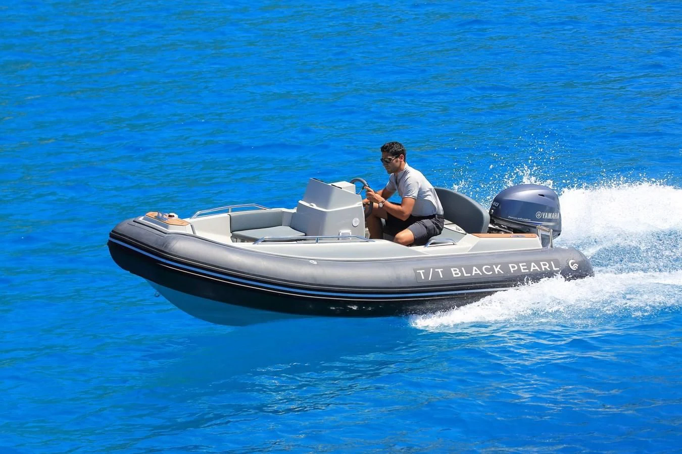 a man driving a speed boat aboard BLACK PEARL Yacht for Sale
