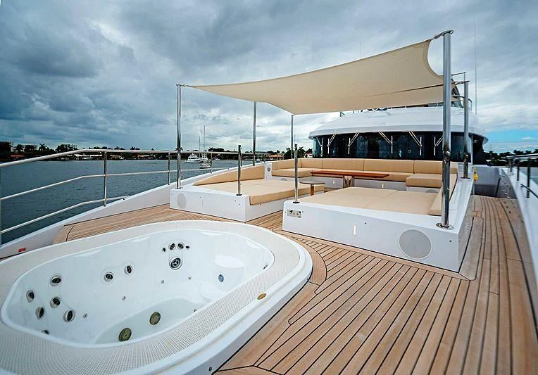 a large white bathtub on a deck with a large white round object on it aboard QUEEN D Yacht for Sale