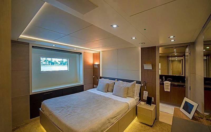 a bedroom with a bed and a mirror aboard QUEEN D Yacht for Sale