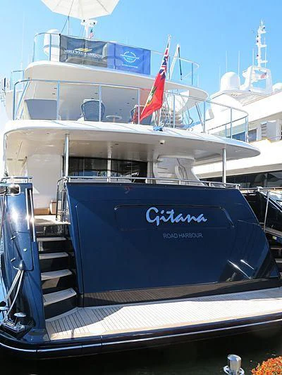 a boat with a flag on the front aboard QUEEN D Yacht for Sale
