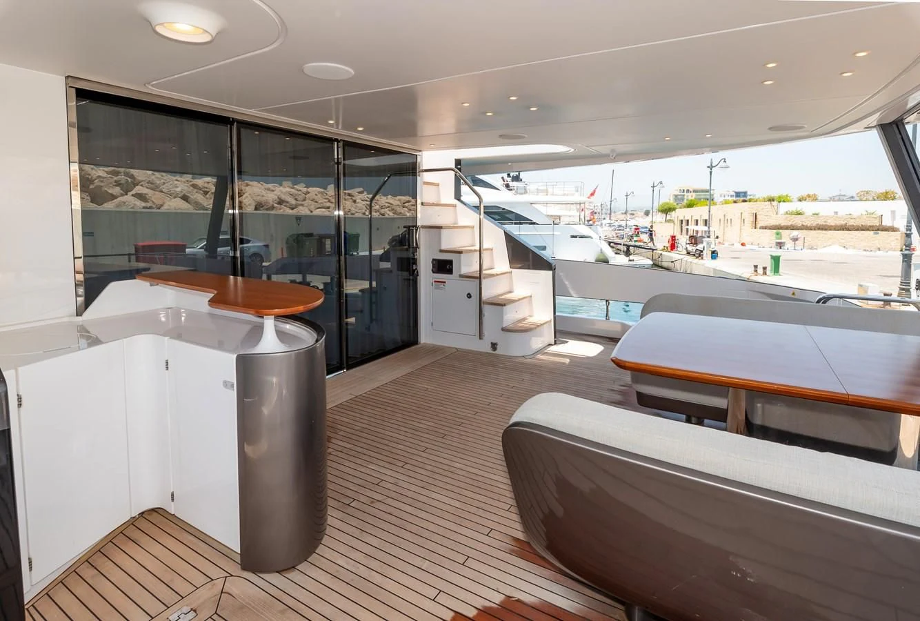 a room with a large window and a table with chairs aboard AZIMUT GRANDE 26/25 Yacht for Sale