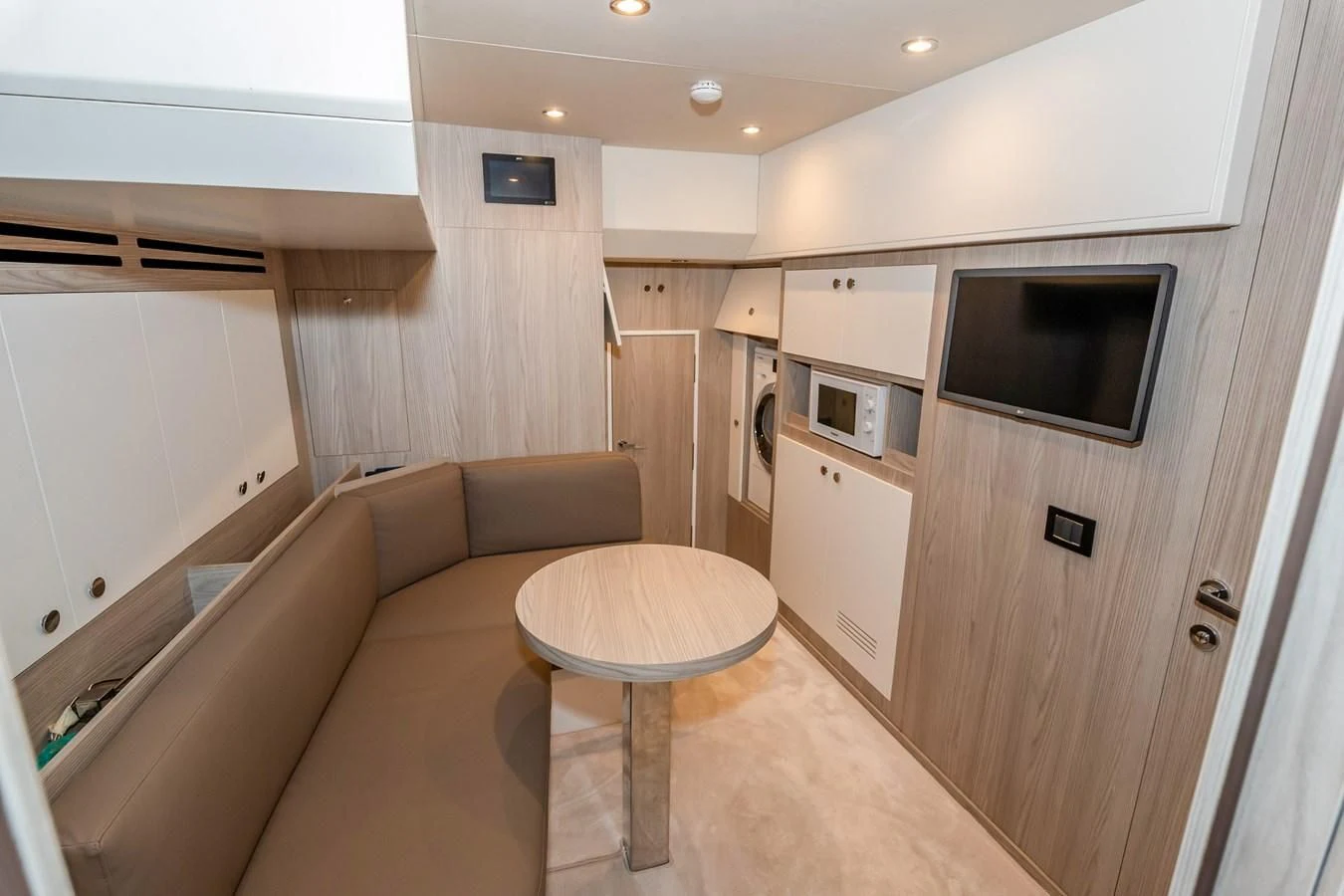 a living room with a couch and a television aboard AZIMUT GRANDE 26/25 Yacht for Sale