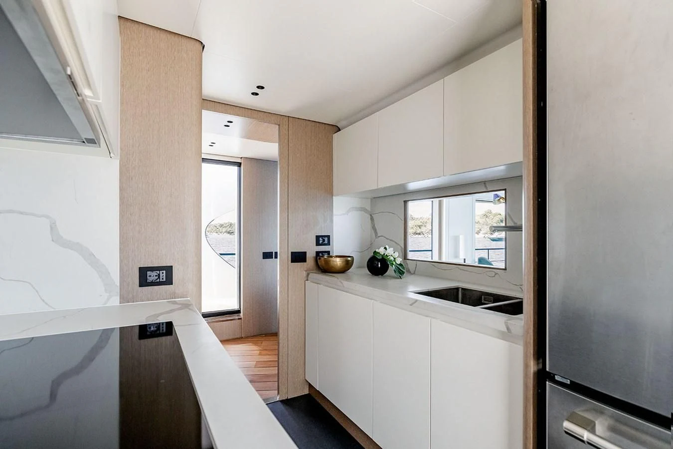 a kitchen with white cabinets aboard AZIMUT GRANDE 26/25 Yacht for Sale