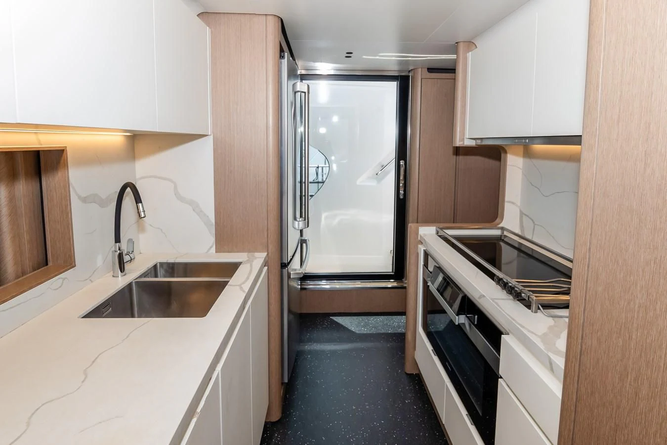 a kitchen with a sink and refrigerator aboard AZIMUT GRANDE 26/25 Yacht for Sale