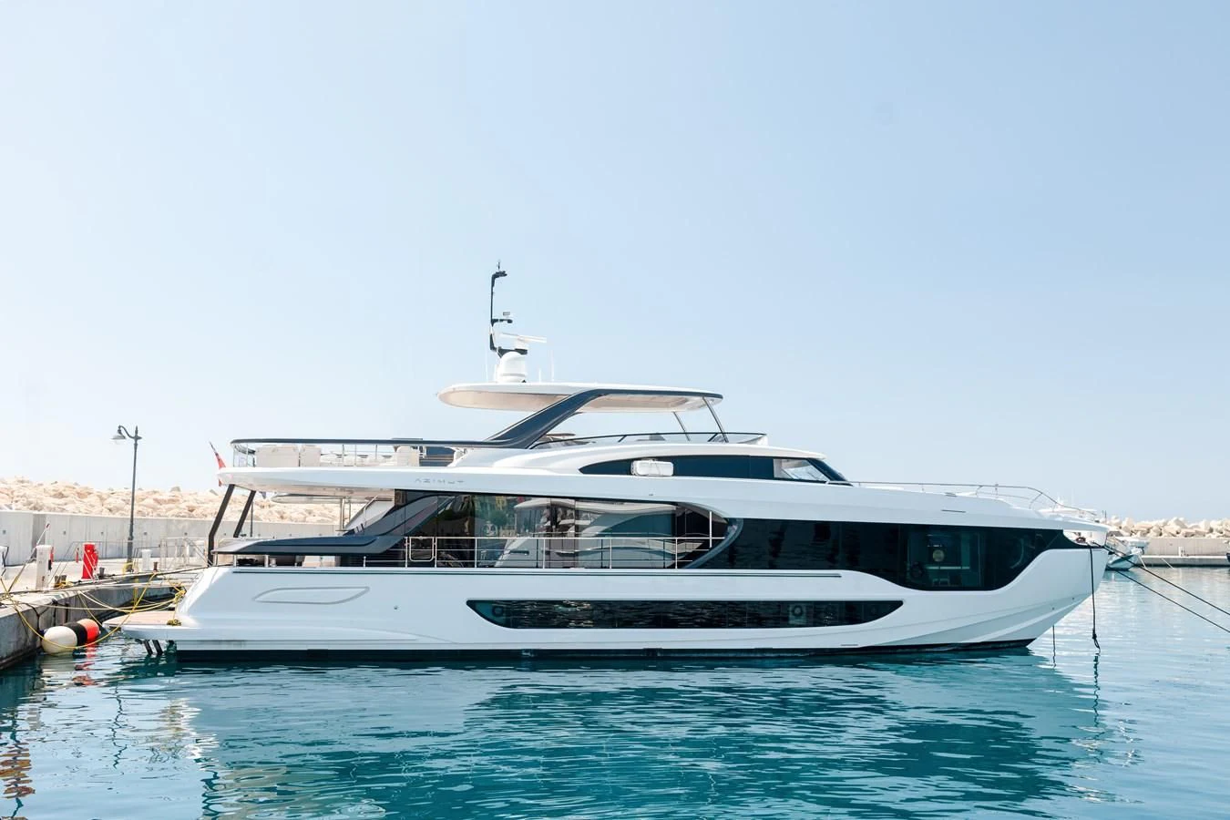 a white yacht docked at a dock aboard AZIMUT GRANDE 26/25 Yacht for Sale