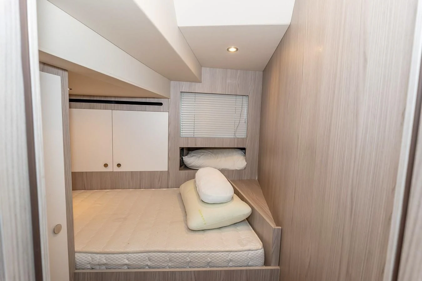 a bedroom with a bed and a window aboard AZIMUT GRANDE 26/25 Yacht for Sale
