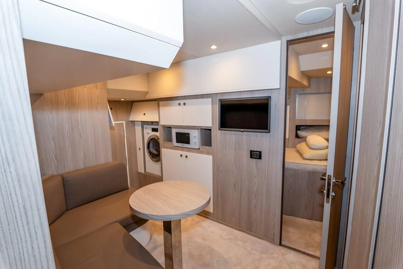a kitchen with a table and microwave aboard AZIMUT GRANDE 26/25 Yacht for Sale