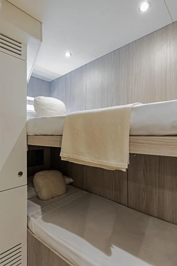 a room with a bed and a wood cabinet aboard AZIMUT GRANDE 26/25 Yacht for Sale