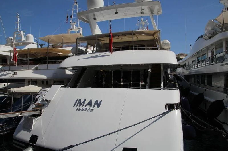 a boat docked at a pier aboard IMAN Yacht for Sale