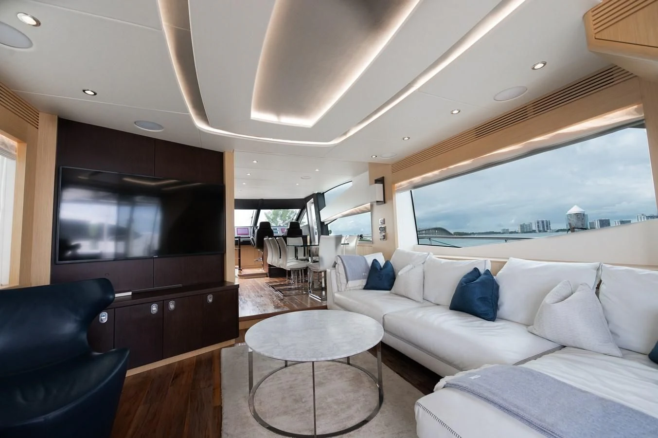 a living room with a large flat screen television and a large window aboard SUNSEEKER 75 YACHT Yacht for Sale