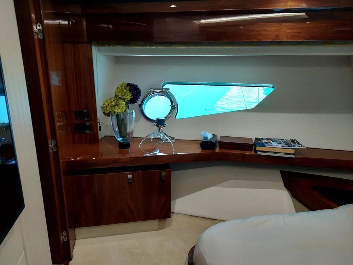 a room with a table and a television aboard SUNSEEKER 75 YACHT Yacht for Sale