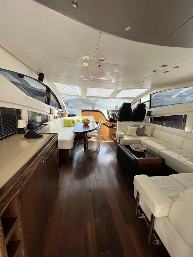 a room with a couch and a table and chairs aboard SUNSEEKER 75 YACHT Yacht for Sale