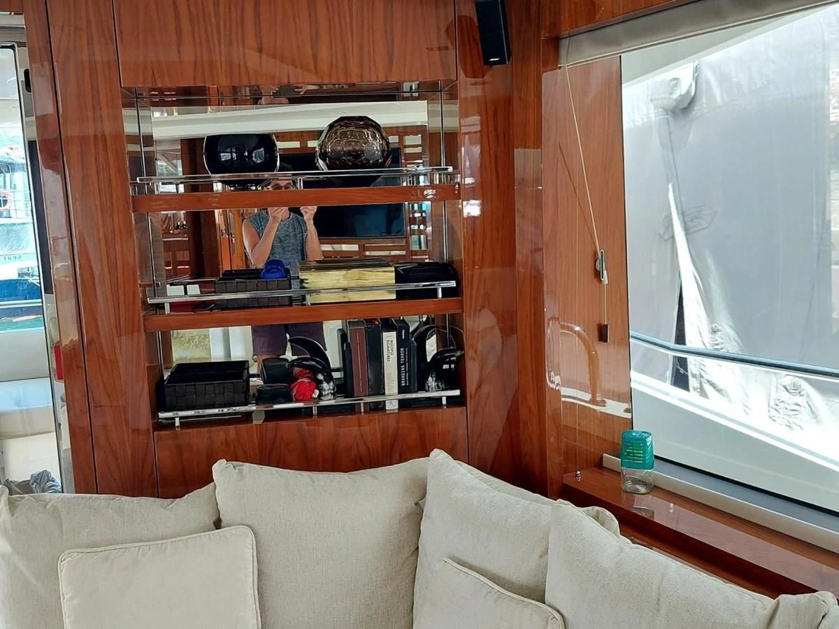 a living room with a book shelf aboard SUNSEEKER 75 YACHT Yacht for Sale