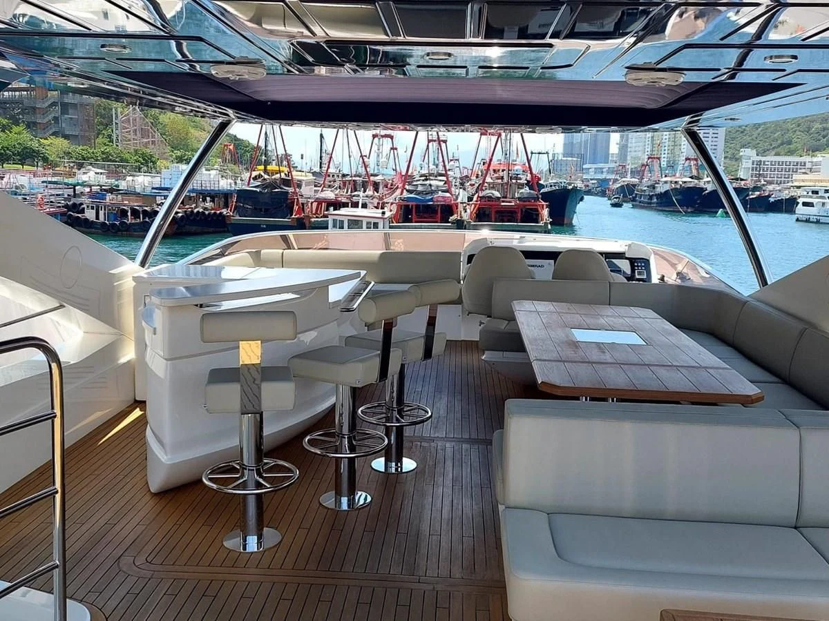a boat deck with a table and chairs aboard SUNSEEKER 75 YACHT Yacht for Sale