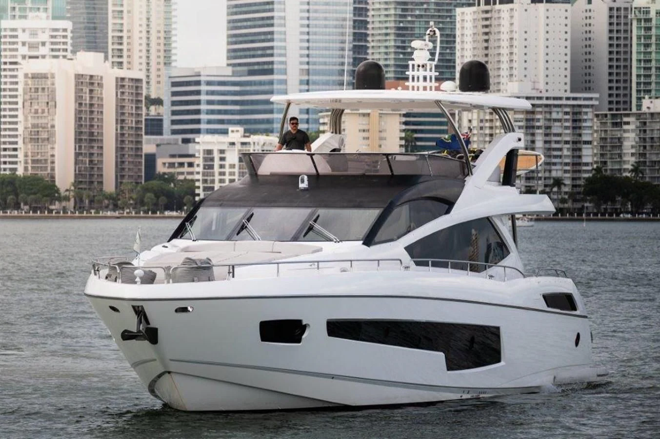 a white boat with a couple of people on it aboard SUNSEEKER 75 YACHT Yacht for Sale